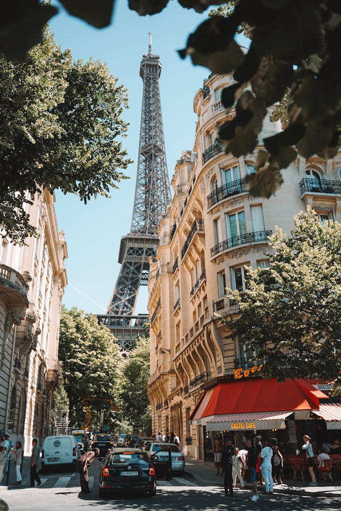 A picturesque Paris street scene featuring the Eiffel Tower with bustling cafes and people.